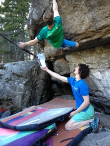 Ondra holds chalk for jakob Schubert as he tries to get it back on some bad holds.